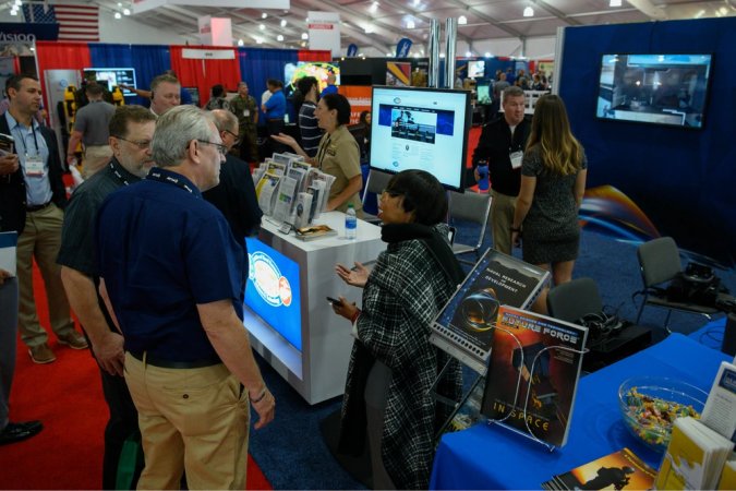 Brenda Pickett, center, director, Office of Small Business Programs at the Office of Naval Research (ONR), talks with visitors to the ONR exhibit at Modern Day Marine. ONR’s Office of Small Business Programs is a small business advocacy and advisory office responsible for insuring that small business, small disadvantaged business, historically underutilized business, veteran-owned small business, service-disabled veteran-owned small business and women-owned small business concerns, including Historically Black Colleges and Universities and Minority Institutions (HBCU/MIs), participate in ONR's acquisition program both as prime contractors and as subcontractors. (U.S. Navy photo by John F. Williams)