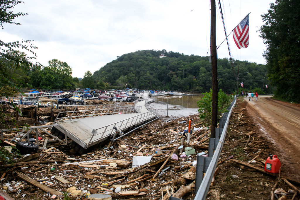 LAKE LURE, NORTH CAROLINA - SEPTEMBER 28: The Rocky Broad River flows into Lake Lure and overflows the town with debris from Chimney Rock, North Carolina after heavy rains from Hurricane Helene on September 28, 2024, in Lake Lure, North Carolina. Approximately six feet of debris piled on the bridge from Lake Lure to Chimney Rock, blocking access. (Photo by Melissa Sue Gerrits/Getty Images)