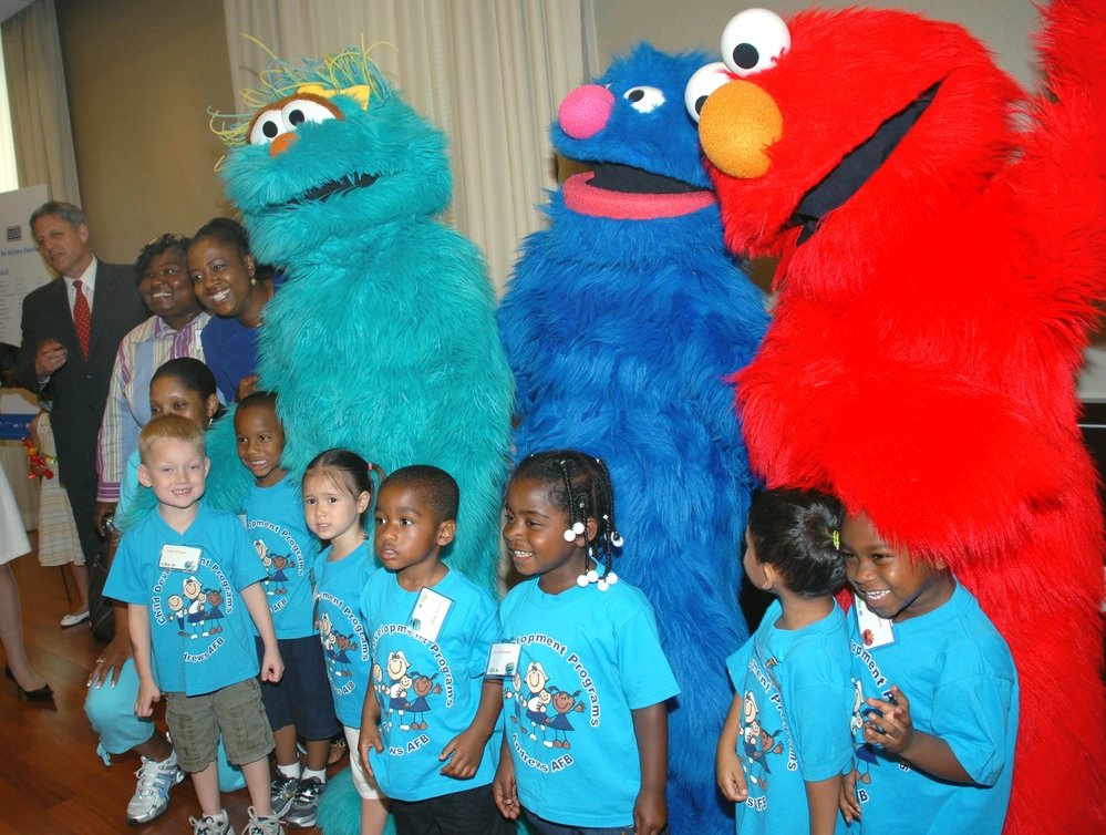 Children from the Andrews Air Force Base hild development center pose for a photo with Sesame Street characters Rosita, Grover and Elmo on June 26, 2008. The muppets were in Washington to help the Sesame Workshop and the United Service Organizations launch "The Sesame Street Experience," the next piece in the workshop's program to help young military children cope with parents' deployments.