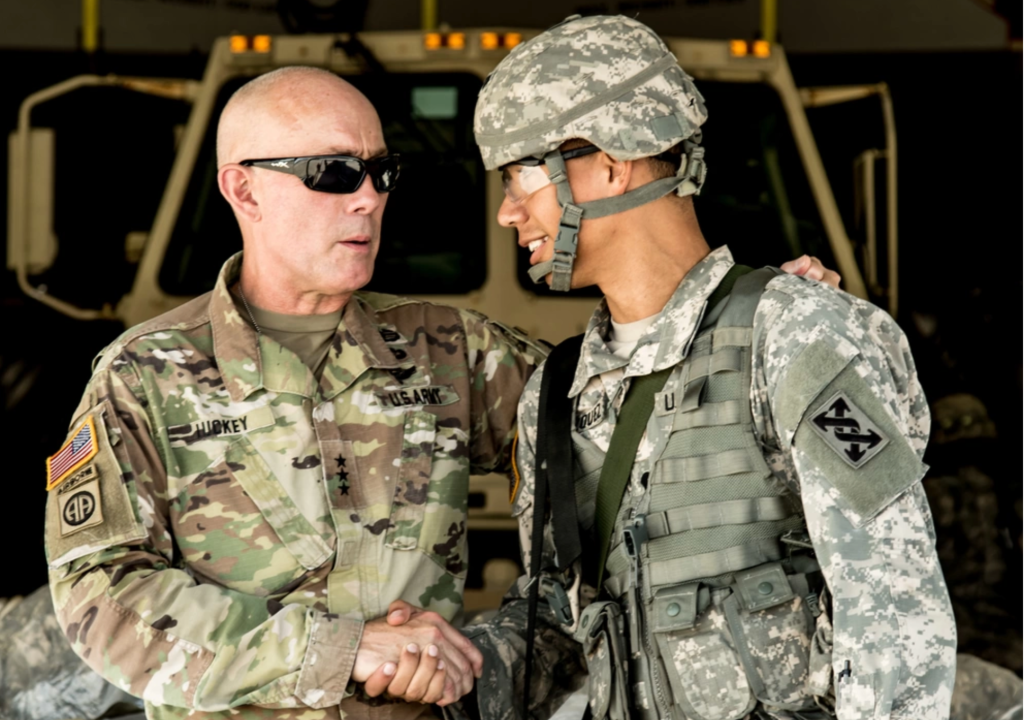 Standing on a ramp of a U.S. Air Force C-17 Globemaster III cargo plane laden with troops and vehicles, U.S. Army Lt. Gen. Charles D. Luckey, chief, U.S. Army Reserve, shakes hands with Spc. Sergio A. Velazquez, a transportation management coordinator assigned to Headquarters and Headquarters Company, 332nd Transportation Battalion, 641st Regional Support Group, during an aerial redeployment training mission Sept. 27, 2017, at MacDill Air Force Base, Fla. Luckey joined Velazquez, a San Antonio, Fla., native and his fellow Soldiers from the 332nd on the flight to observe firsthand how the battalion planned, organized and executed a Deployment Readiness Exercise Level III. DRE Level III evaluates a unit’s capability to rapidly mobilize at its home station and deploy overseas within 96 hours. (U.S. Army photo by Sgt. John L. Carkeet IV, 143d ESC)