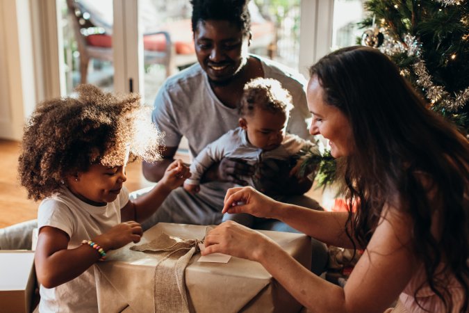 Family opening presents together on Christmas morning