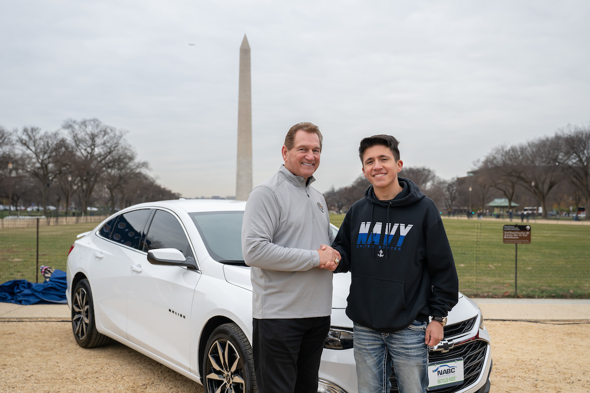 NFL legend Joe Theismann (left) poses with U.S. Navy Seaman Matthew Walker who was gifted a vehicle by USAA at USAA’s Army-Navy Game NABC Recycled Rides Car Gifting event in Washington on Friday, December 13th, 2024. The event was held to showcase USAA’s commitment to serving the military community and the spirit of ‘America’s Game.’ (Photo by Joy Asico-Smith/AP Images for USAA)