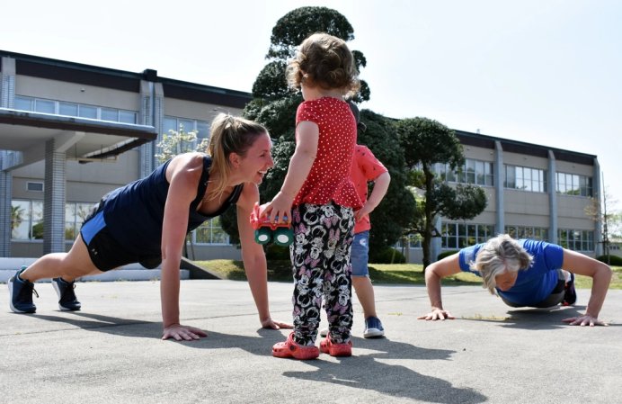 Morgan Hargus, a coordinator of the Camp Zama Stroller Warriors, does strength training in front of the U.S. Army Japan Headquarters at Camp Zama April 23, 2019.