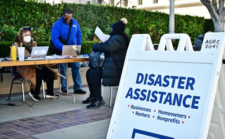 Evacuees and victims of the Eaton Fire meet with FEMA and SBA officials for disaster assistance on January 21, 2025, at the Pasadena Convention Center where evacuees have been taking shelter. FEMA has received more than 91,000 applications for assistance from both Los Angeles City and County, and has delivered more than $32 million to wildfire survivors so far. The deadline to register for FEMA and SBA asisstance is March 10, 2025. (Photo by Frederic J. BROWN / AFP) (Photo by FREDERIC J. BROWN/AFP via Getty Images)