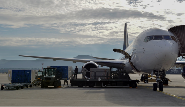 Airmen from the 721st Aerial Port Squadron load cargo into a Boeing 767 Jan. 27, 2016, at Ramstein Air Base, Germany. Once a plane arrives, Airmen unload the cargo belonging to passengers on the inbound flight and quickly fill the storage with the containers full of the outbound flight passengers’ belongings.