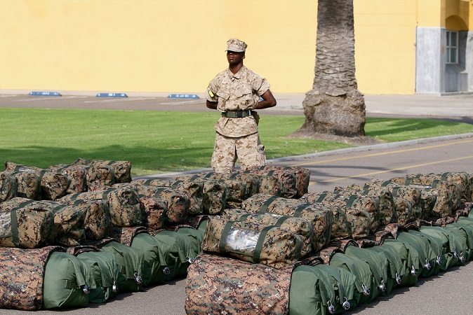 Identical bags line the pavement. A way to mark yours is critical in our useful gear list. 