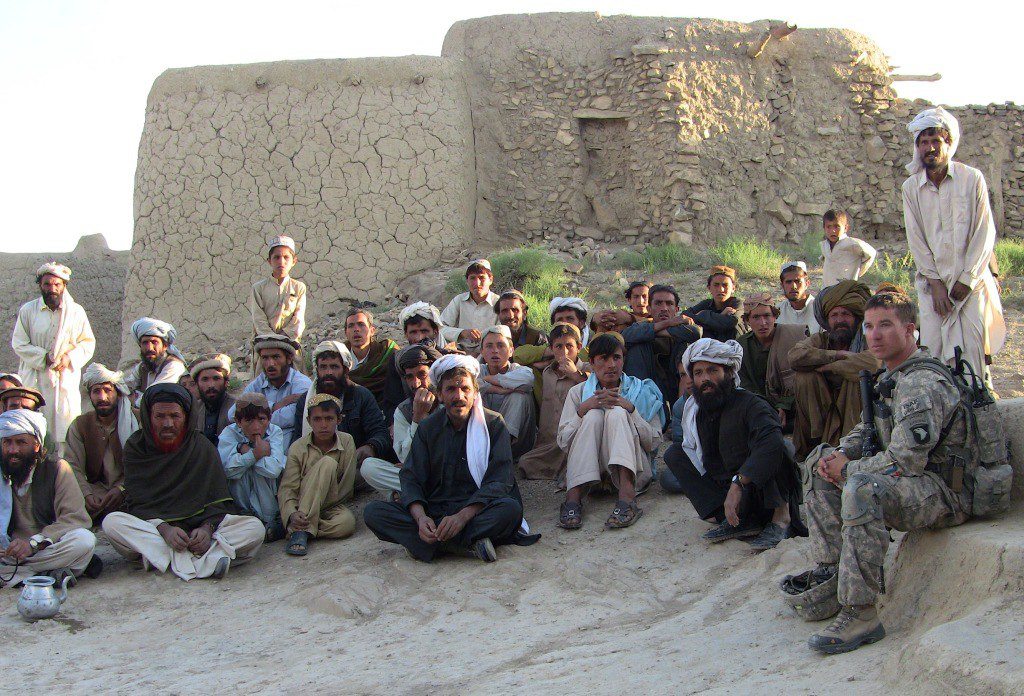 Soldiers gathering locals for a coalition plan