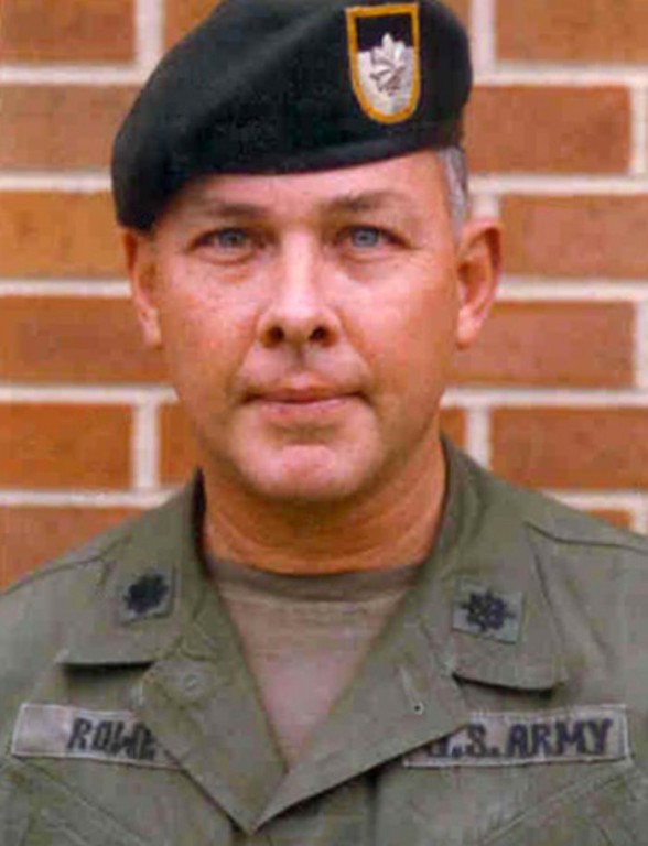 James N. Rowe in Army uniform, in front of a brick wall