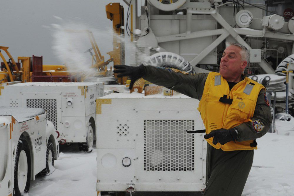 Airman throwing snowball in the cold