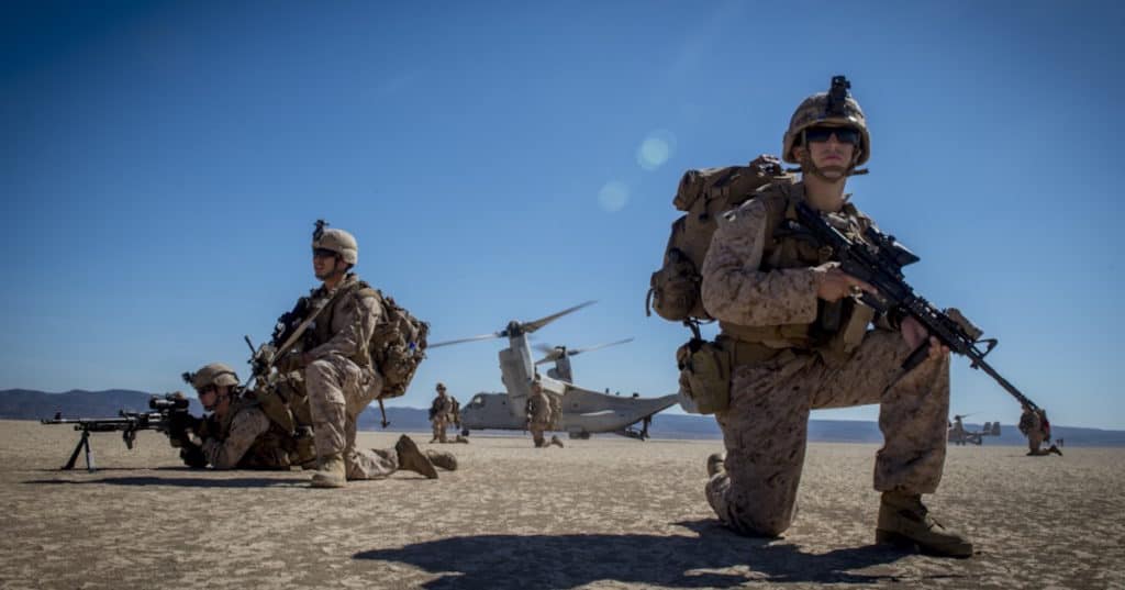 v-22 osprey behind marines