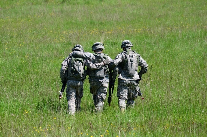 Three soldiers walking together. Usually, the buddy system works in pairs