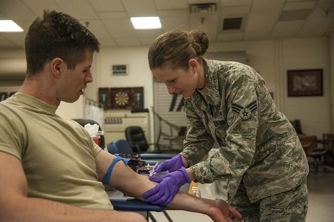 A soldier receiving a shot. With the new policy, some troops may be kicked out after a prolonged injury.