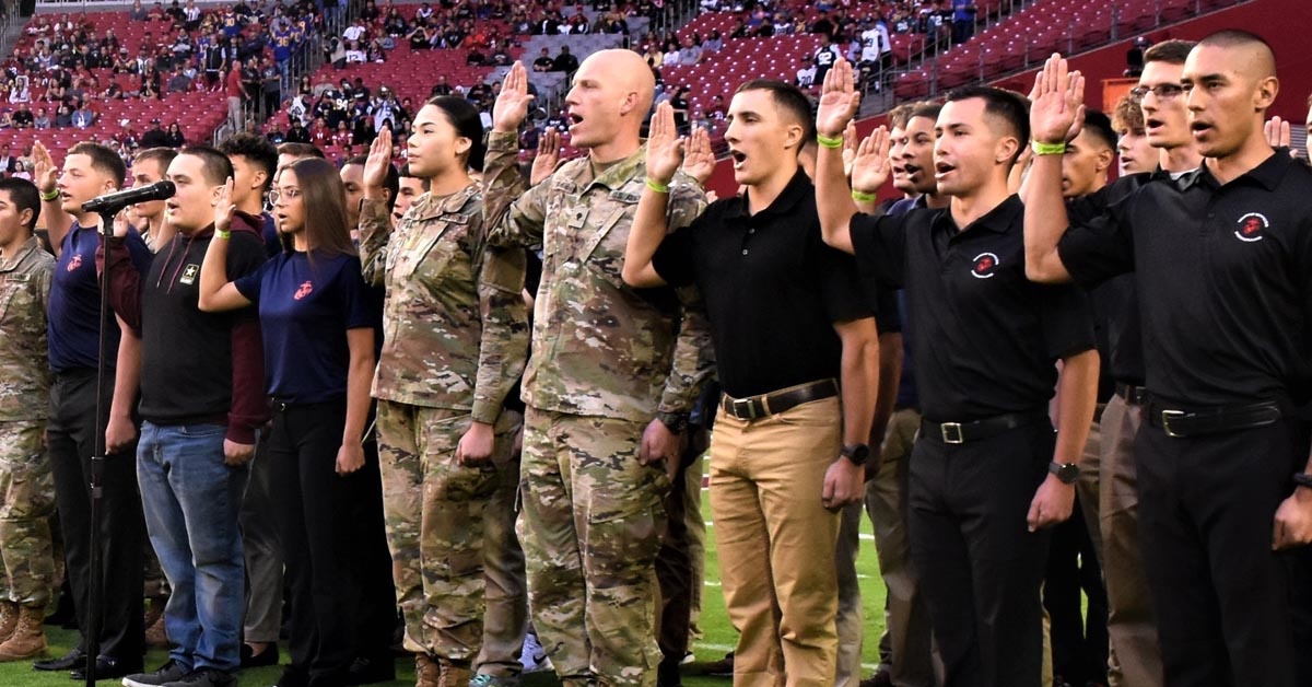 An NFL player and West Pointer reenlisted troops before the Cardinals-Rams game